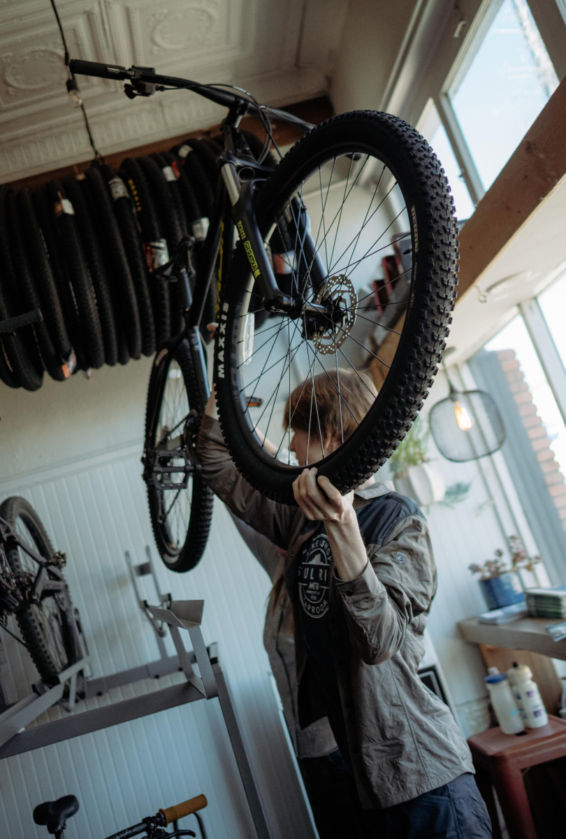 A Teenager lifting a bike in Soul Ride Bike Shop