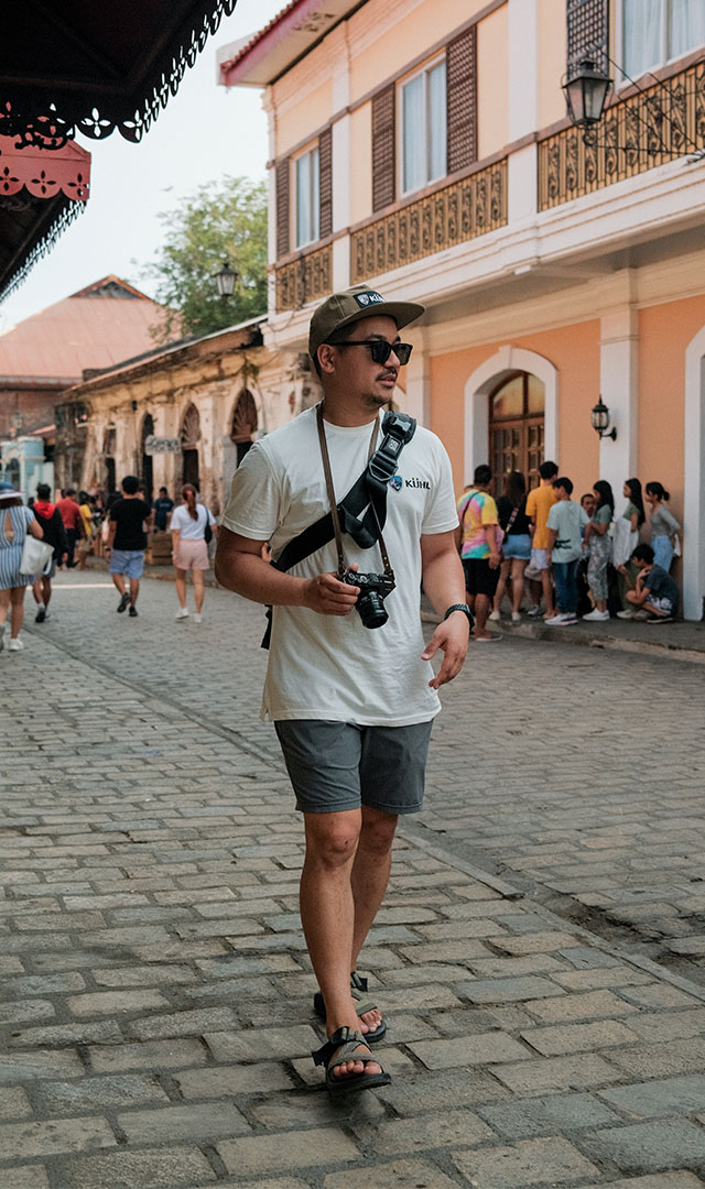 Ryan walking down a cobblestone street in Philippines 