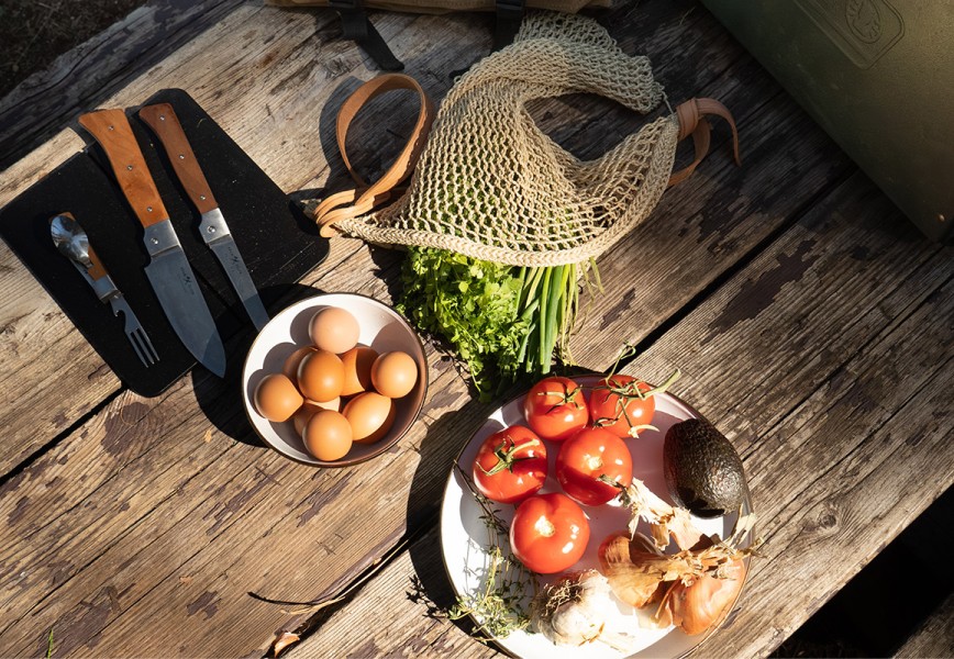 Elevated camping cooking ingredients on a wooden table