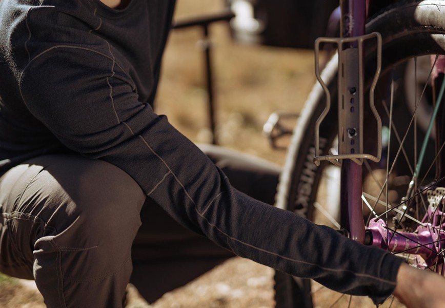 A man fixing a tire of his bicycle in fleece fall jacket