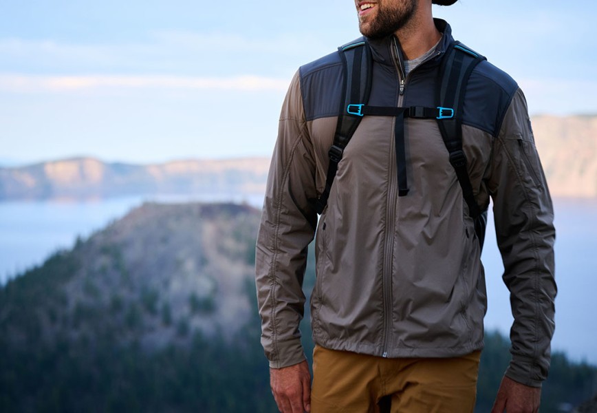 A man atop a summit in The One Jacket