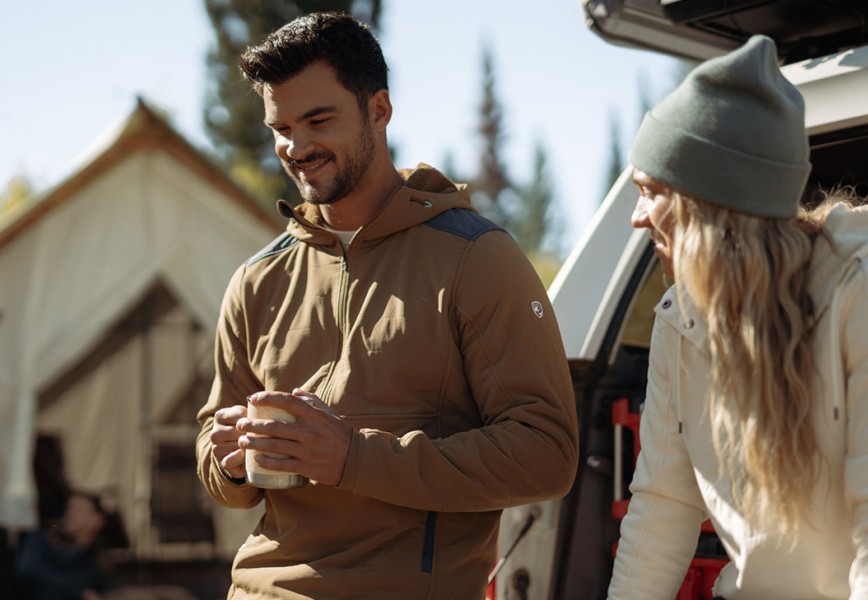 A man and a woman glamping in fall jackets