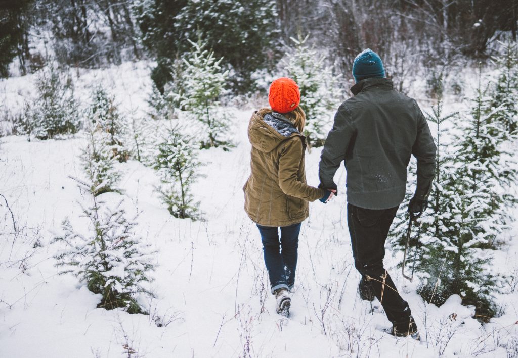 The Magic of Snow: A man and a woman walking down a snowy path, clad in KUHL clothing.