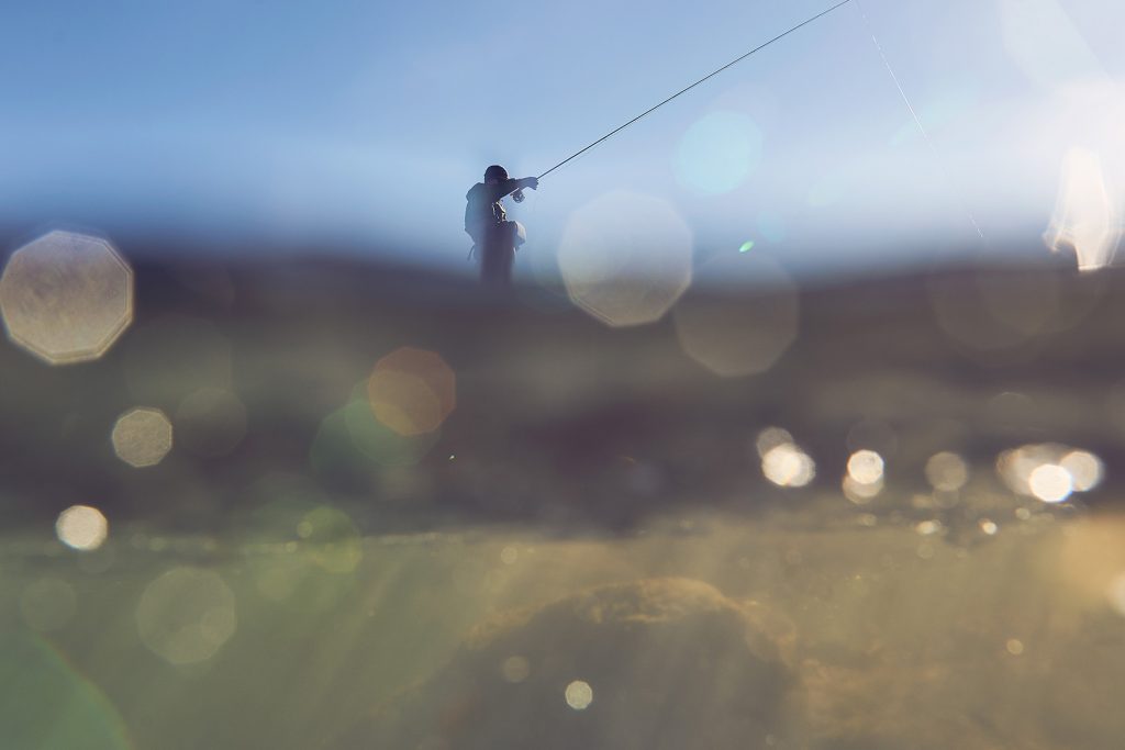 Safety Awareness for Inland Anglers - Submerged Image of a man in KUHL clothes fishing