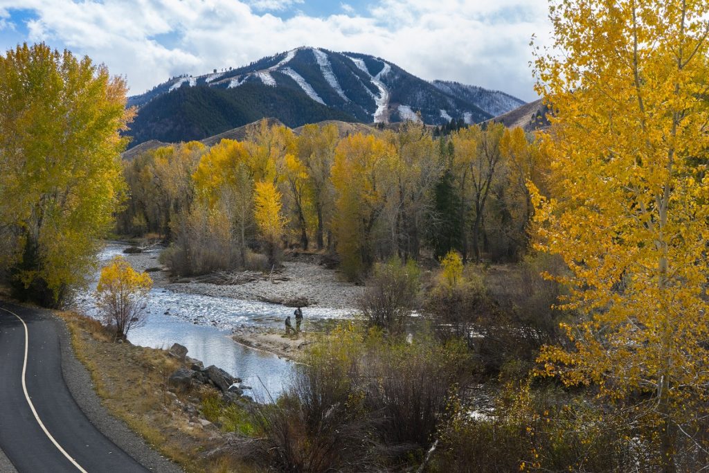 Bearanoid article image - two men standing next to a forest creek wearing KUHL clothing,.