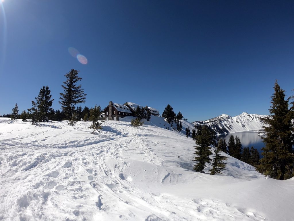 snowy plain with lodge in the background