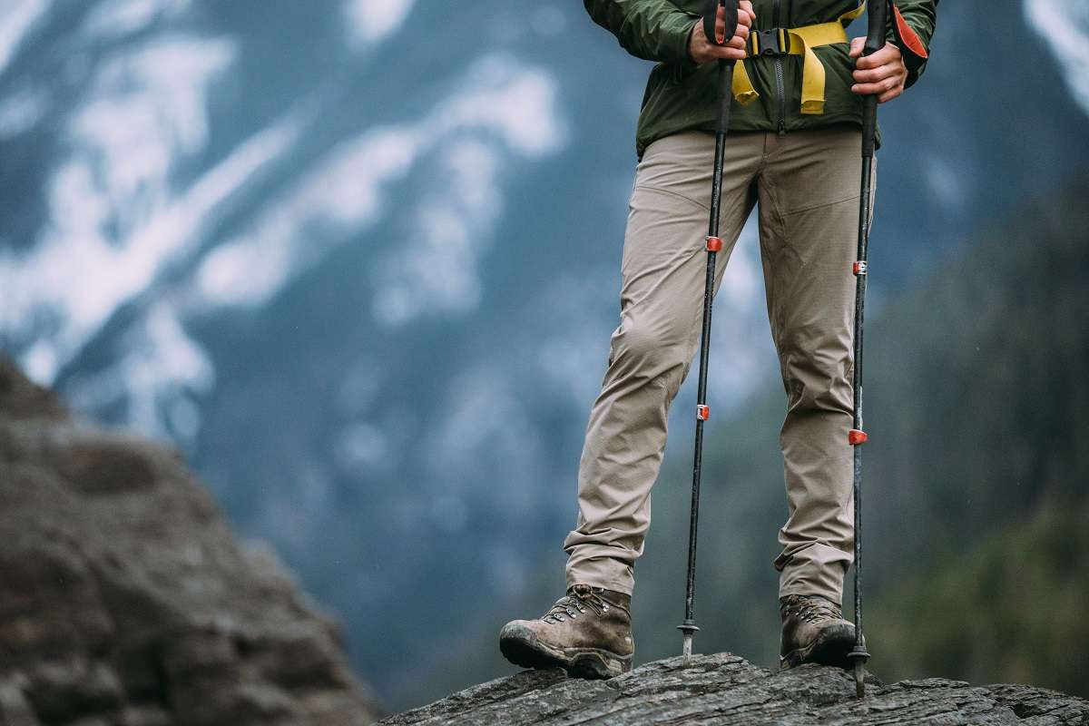 man standing with trekking poles