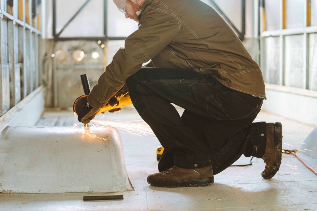 a man kneeling while welding