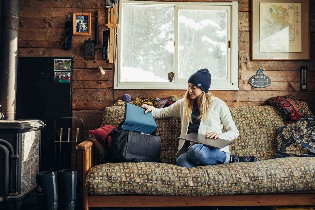 girl sitting on couch in front of white window