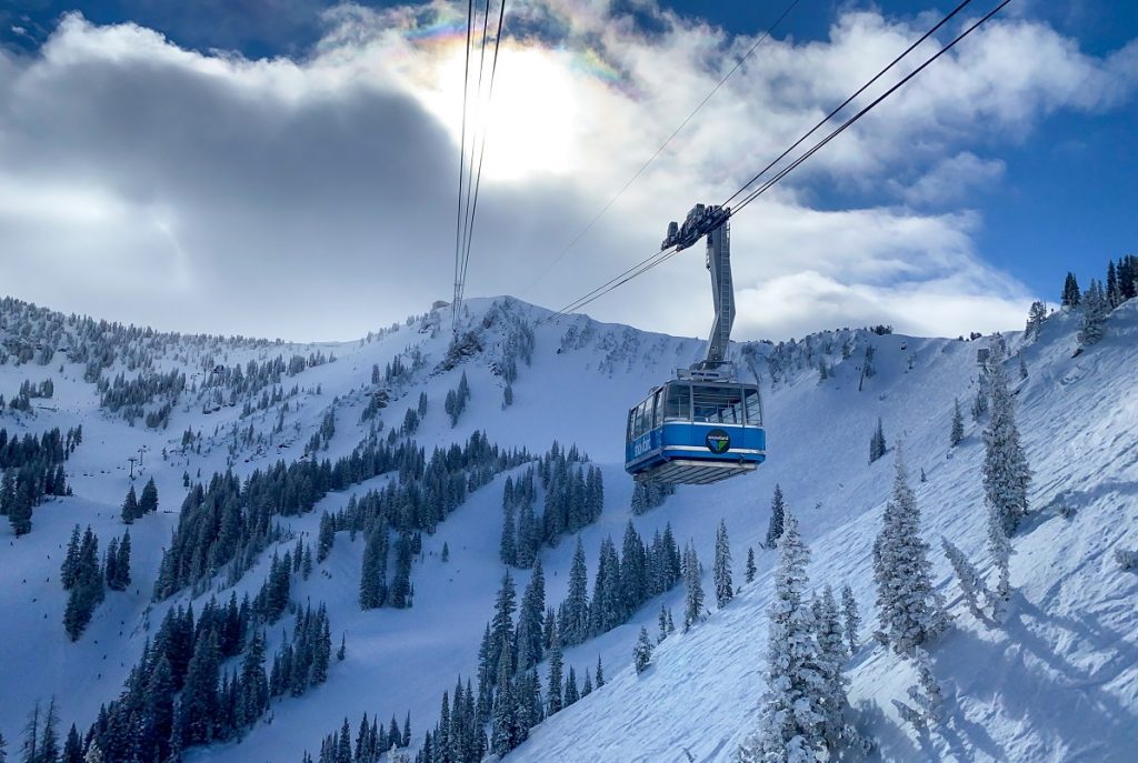 blue tram above the snowy grounds