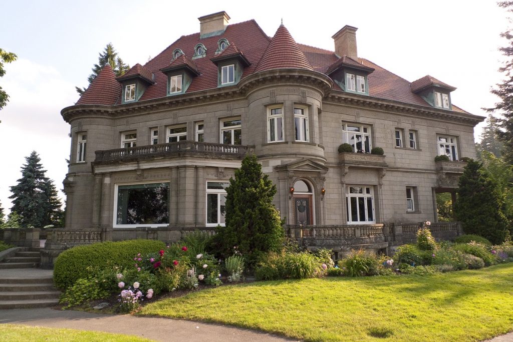 historical mansion with green grass in front during daytime