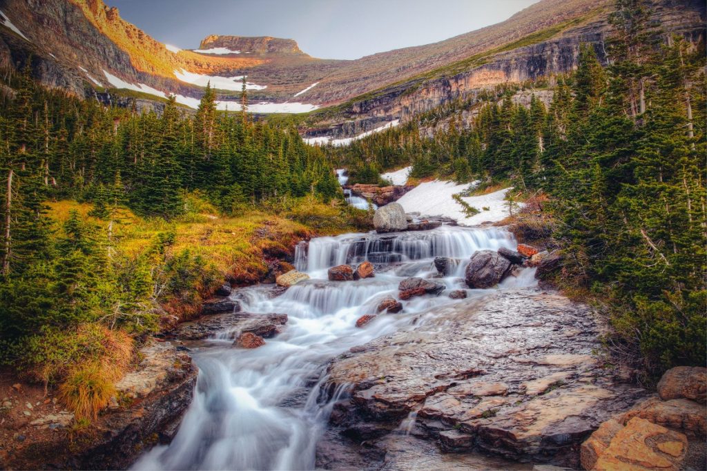 flowing water surrounded by mountains