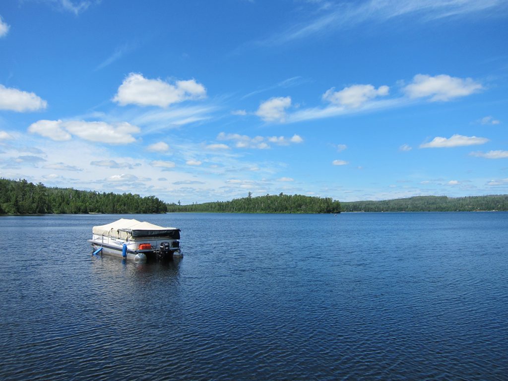 pontoon boat on body of water